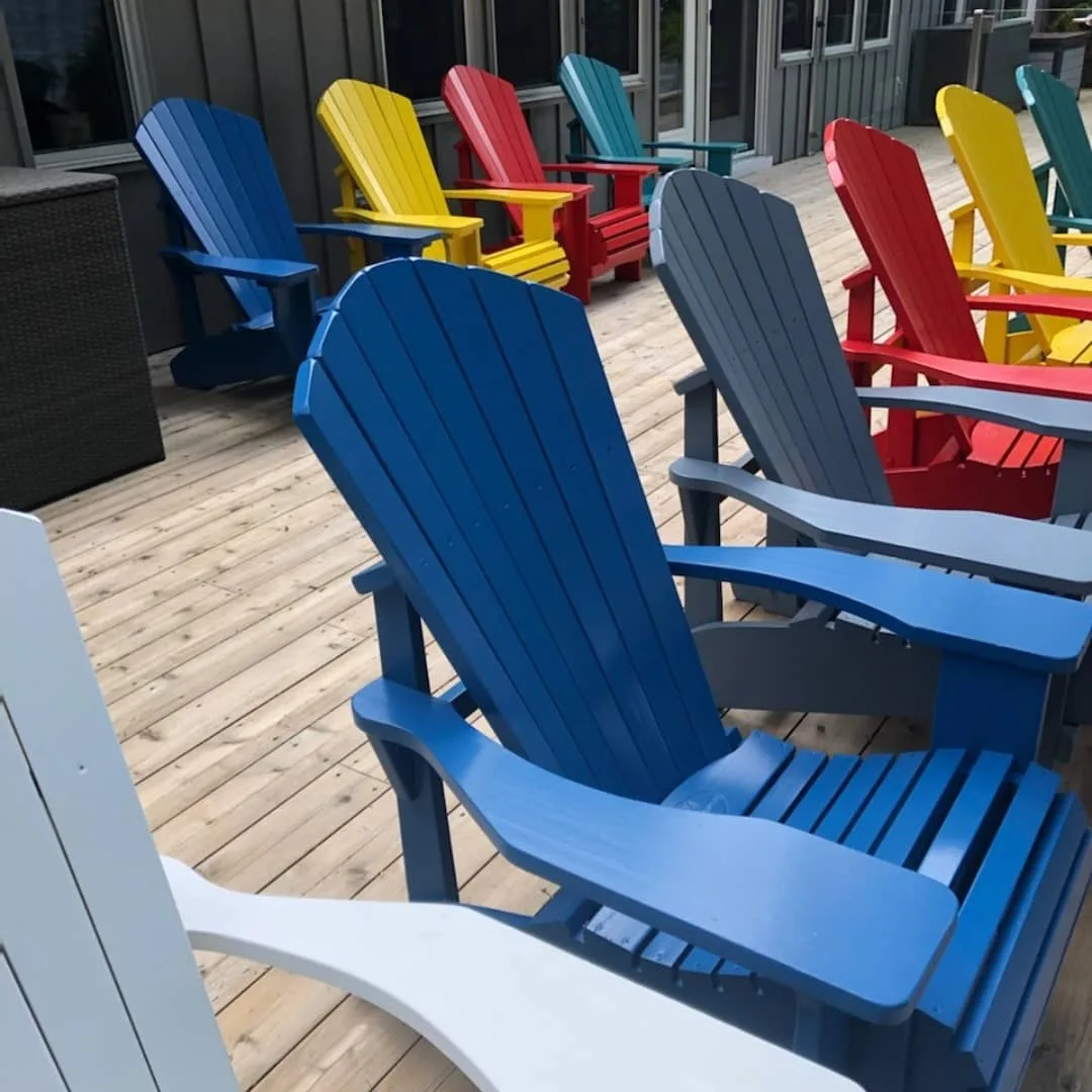 Adirondack chairs spray finished by TAG in cheerful blue, green, yellow and red